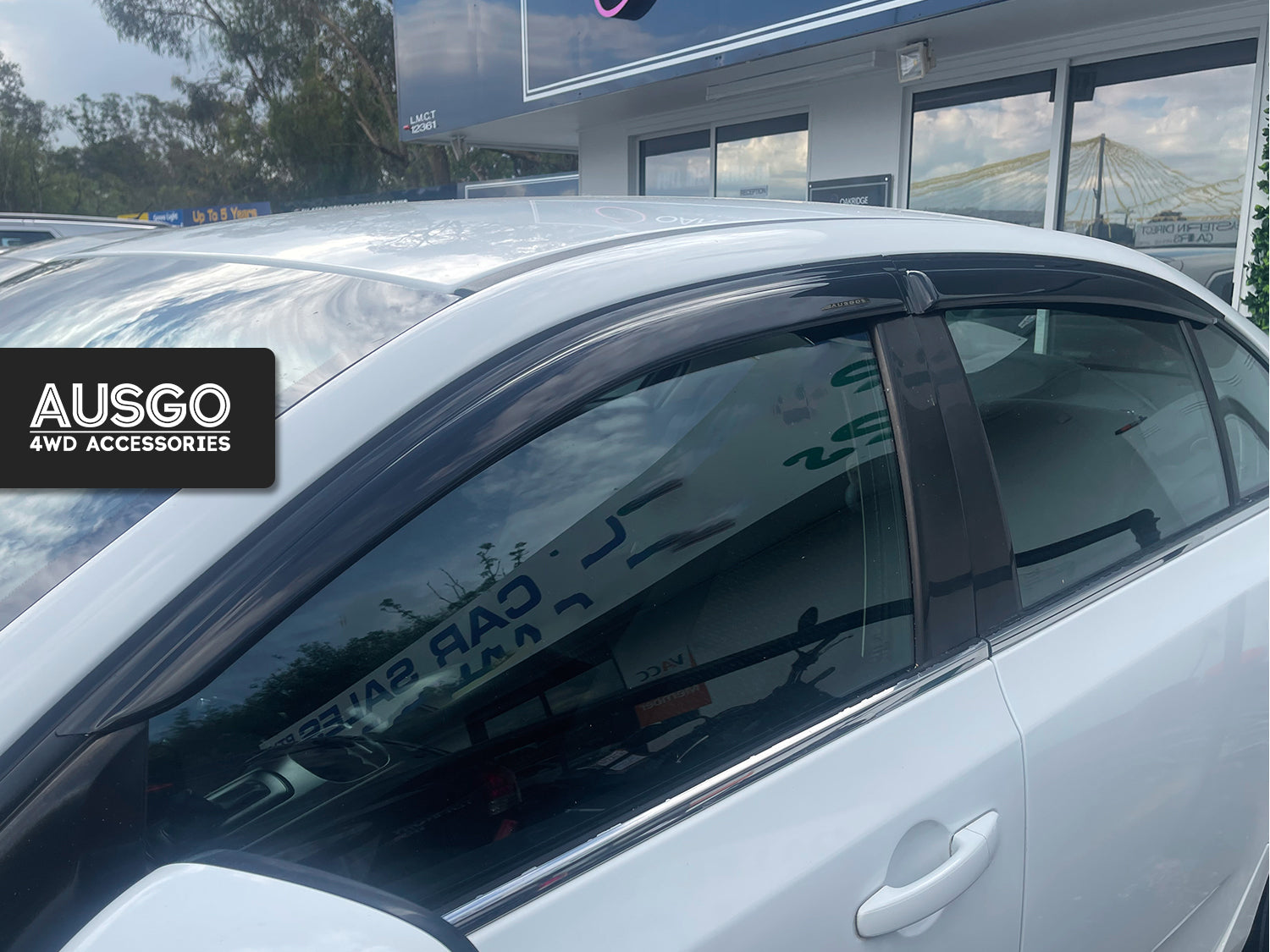 Side view of a Ford Falcon with weather shields attached to the windows.